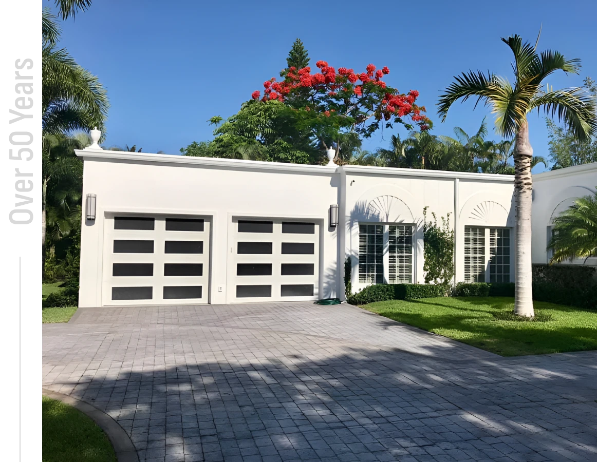 Modern white house with palm trees.