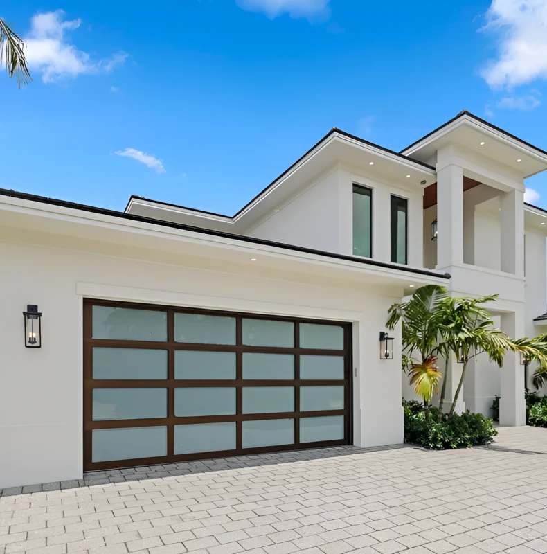 Modern white house with large garage door.